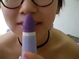 Asian lady rubs her cunt with a toy