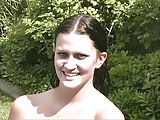 Busty brunette gets wet outside then squeezes tits