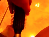 Girl playing with a hairbrush