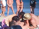 four friends have sex on nude beach in front of crowd