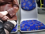 Touching her legs in fishnet stockings in a bus