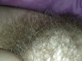 thick hairy pussy under the sheets.