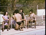 Brunettes sitting poolside harass guy on a leash