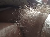 rubbing her natural hairy mound.