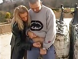 Blond gives handjob to guy in parking lot