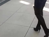 woman trying Thigh High Boots in public