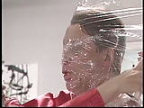 Guy getting wrapped in plastic