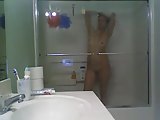 Girl in glass taking a shower