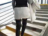 Chick in black boots and black stockings going upstairs