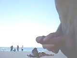 naked dude walking on the beach and masturbates his dick