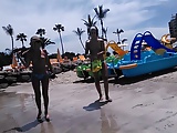 Two candid women topless on beach