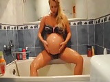 Pregnant Amanda is taking a shower